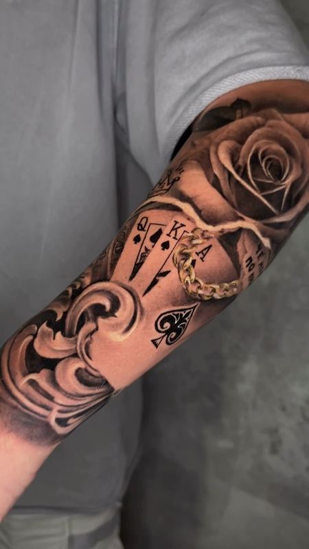 Rose, cards & chain forearm – tattoo by DMTcollective, Karmiel