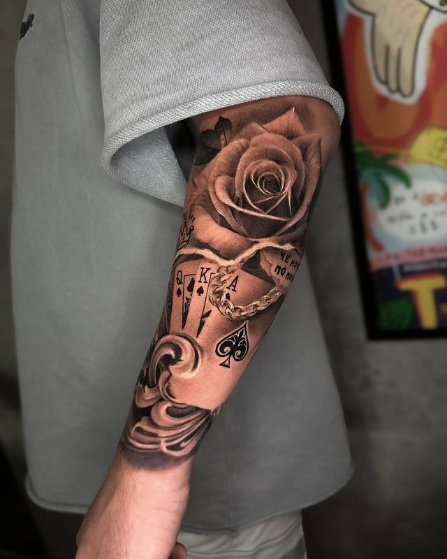 Rose & cards, black and grey – tattoo by DMTcollective, Karmiel