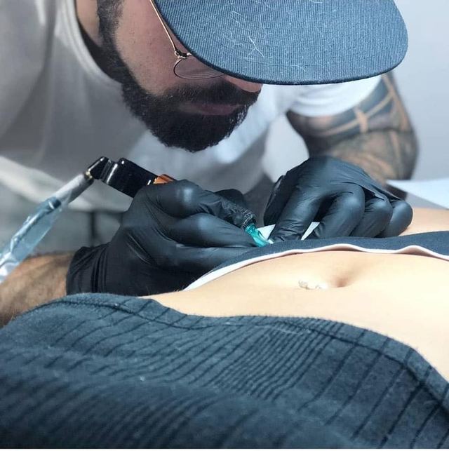 A tattoo session in progress at DMTcollective